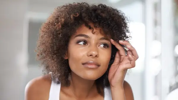 Woman looking at her eyebrows