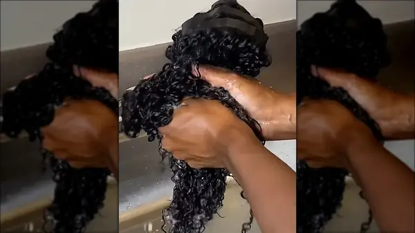 A woman washing her clip-in hair extensions