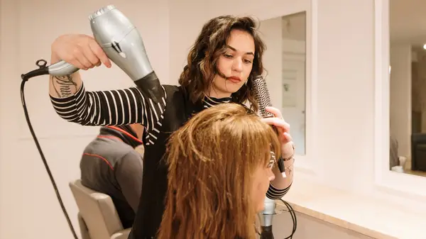 Hairdresser doing woman