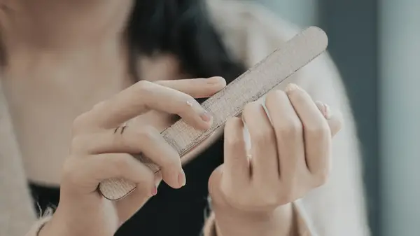 woman filing nails