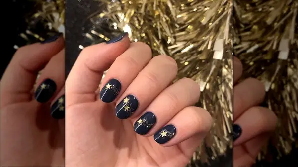 Navy manicure with gold sparkles and stars