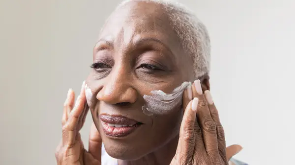 woman using moisturizer