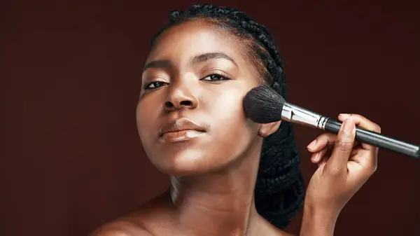 Woman using makeup brush