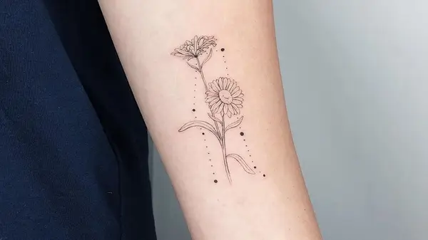 A simple black and white aster tattoo with a constellation in the background 