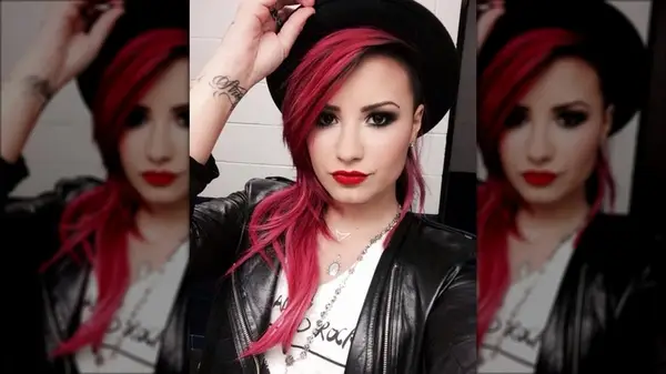 Demi Lovato taking a selfie with dark pink hair
