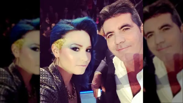 Demi Lovato posing with Simon Cowell