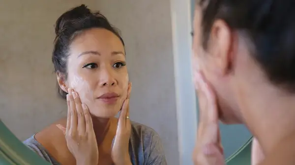Woman exfoliating her face