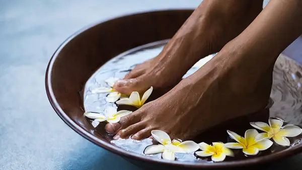 Soaking feet in basin