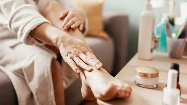 Rubbing lotion on foot