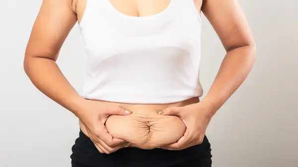 woman pinching loose skin