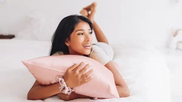 woman cuddling pillow silk case