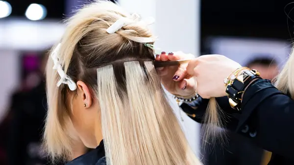 woman getting hair extensions