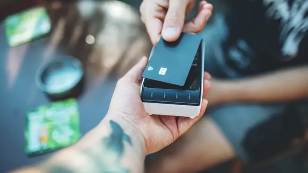 person with tattoo paying