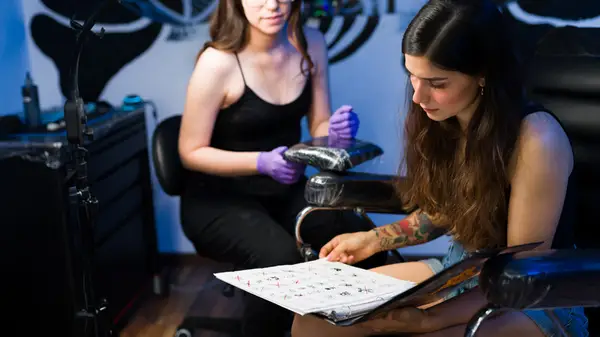 woman choosing tattoo 