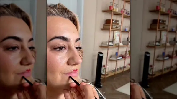 Violette applying lipstick using the 