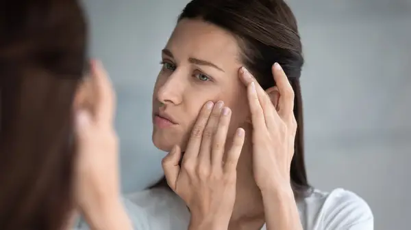 Woman looking at skin