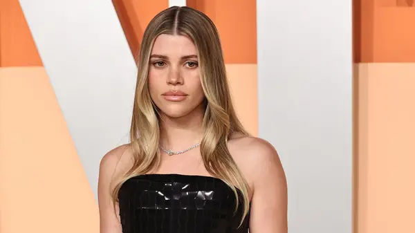 Sofia Richie Grainge posing at the Vanity Fair Oscars Party with her long hair slightly wavy