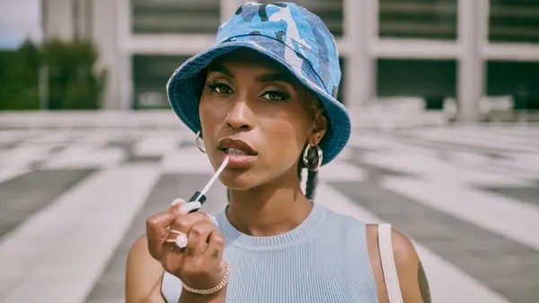 Woman applying lipgloss