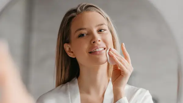 Woman applying skincare