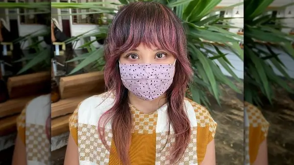 Woman in mask with pink hair