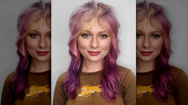 Person smiling with pink wolf cut