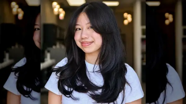 Woman with long, dark hair smiling