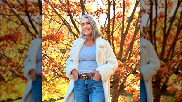 A woman on Instagram in the fall foliage wearing jeans with a lob cut