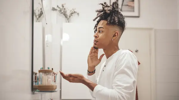 Person applying face oil