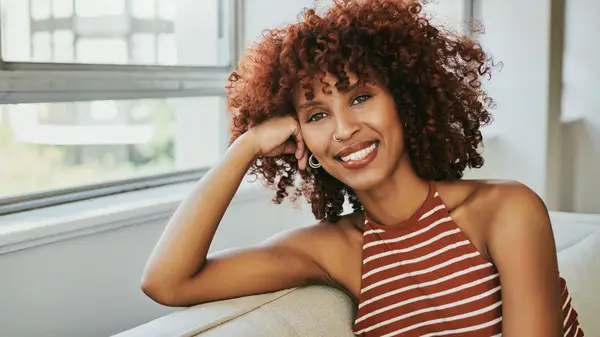 Curly haired woman smiles