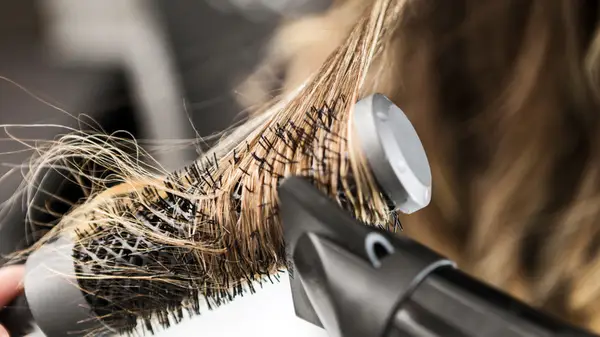 Styling hair with round brush