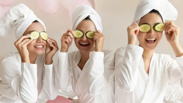 Women with cucumber on their eyes