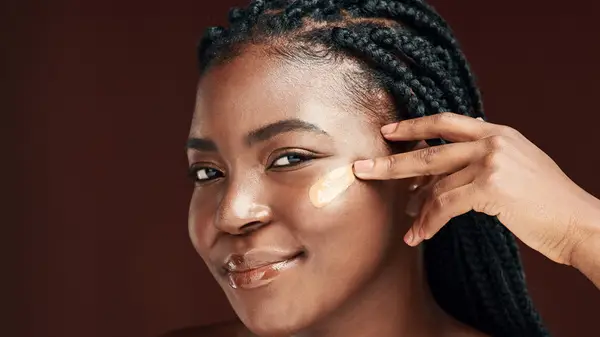 Woman applying concealer