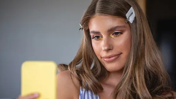 Woman doing her makeup 