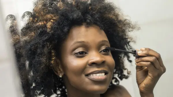 Woman applying mascara