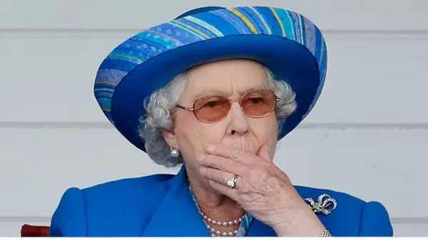 Queen Elizabeth with her hand over her mouth