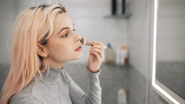 Woman applying foundation