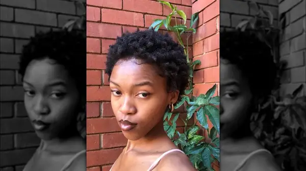 Woman with short definied afro and baby hair