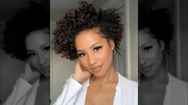 Woman with curly bob style with a side part