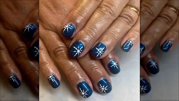 Dark blue snowflake manicure