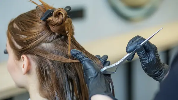 Woman having her hair dyed