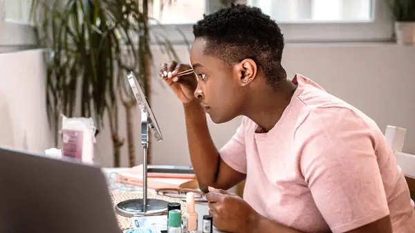 Person tweezing brows