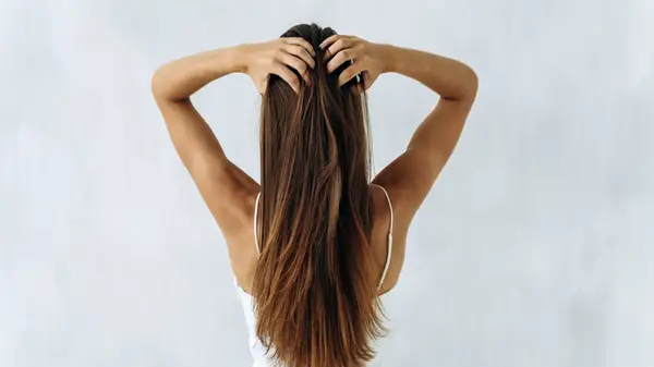 A woman running her hands through her hair