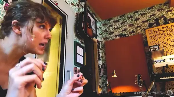 Still of Taylor Swift looking off-camera while working on the song 