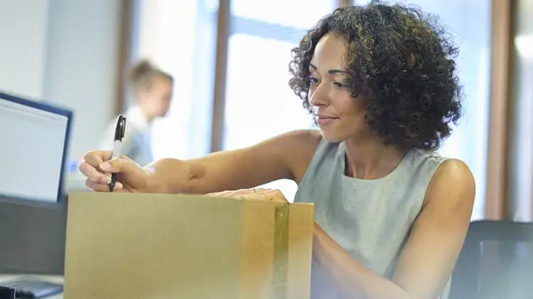 Woman labeling package