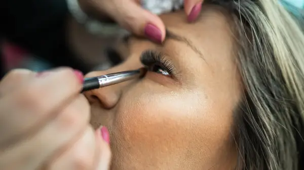 Applying eyeshadow under the eye