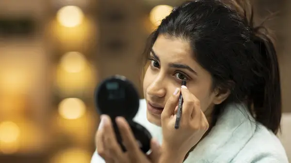 Woman applying eyeliner