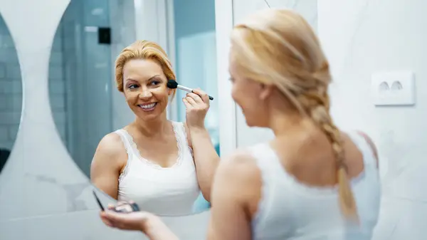Woman applying makeup