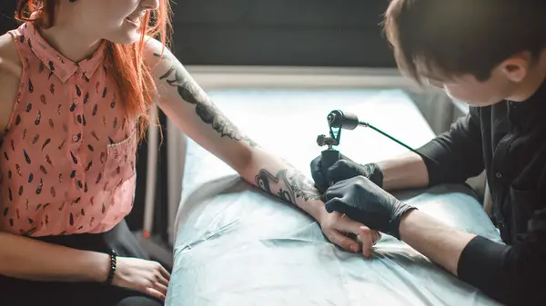 Woman getting a tattoo