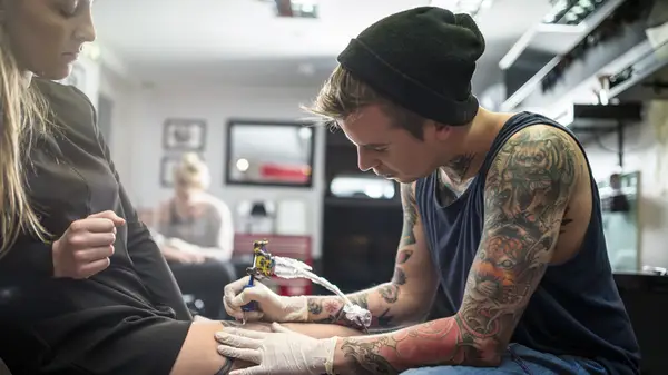 Woman getting a tattoo