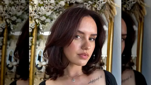 A woman with a dark brown layered bob